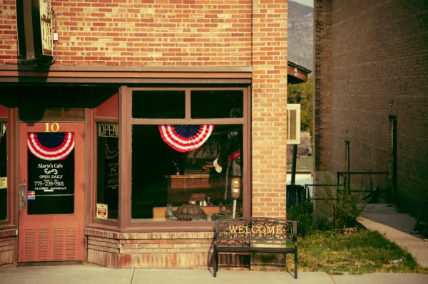 Photo of buildings with a welcome bench